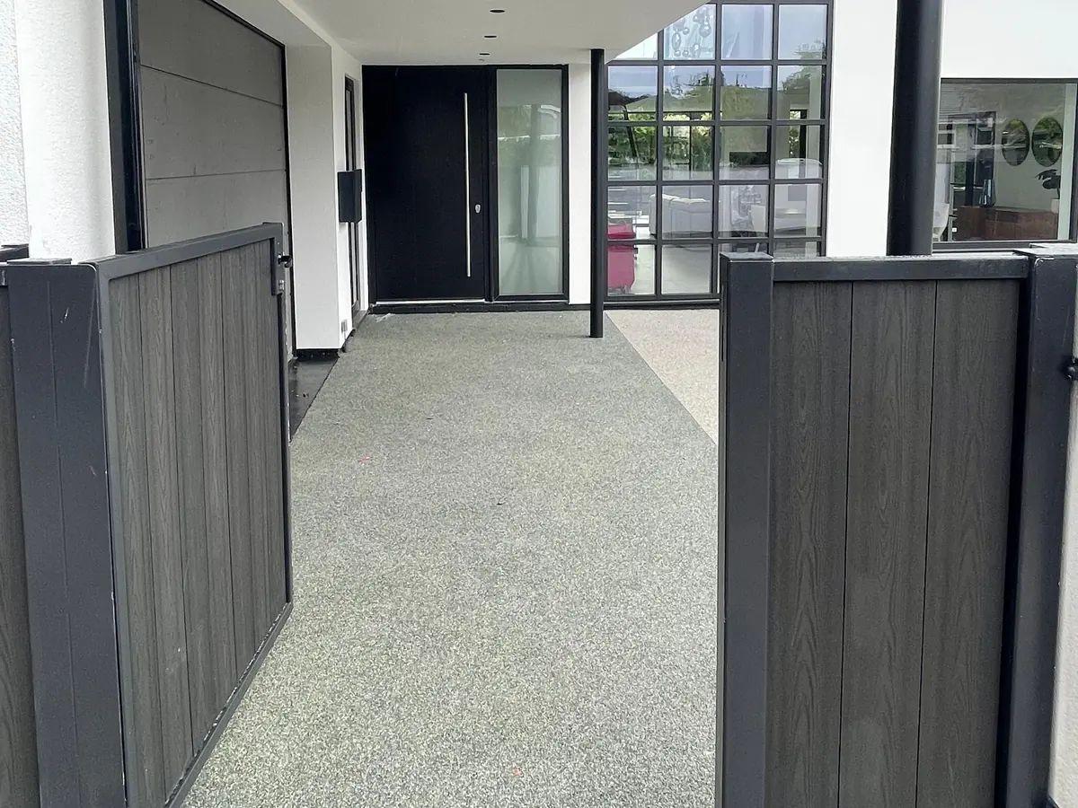 Resin-bound path through new gates to a modern front door, by Robinson Brickwork & Paving